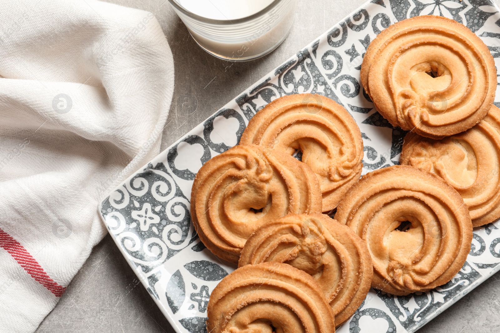 Photo of Plate with Danish butter cookies on grey background, top view