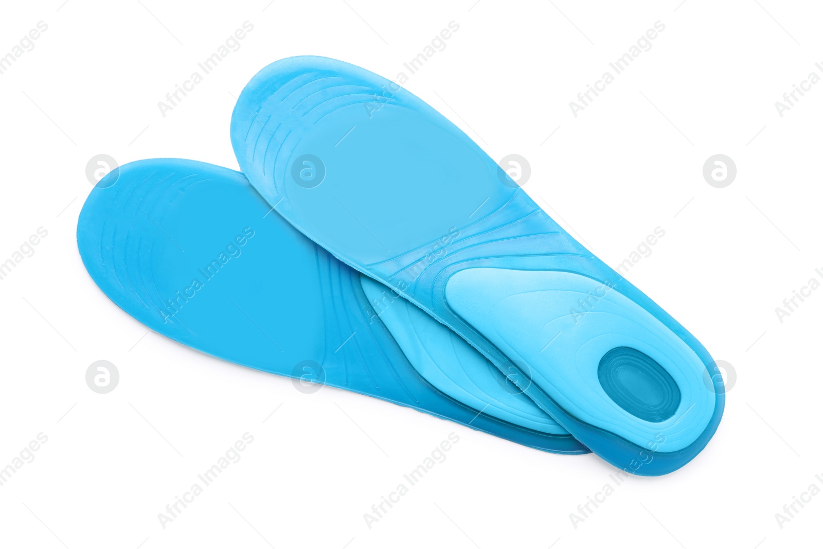 Photo of Light blue orthopedic insoles isolated on white, top view