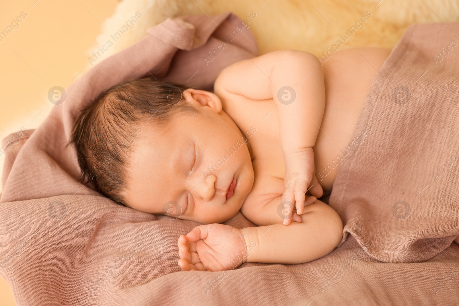 Photo of Adorable newborn baby sleeping on blanket against beige background