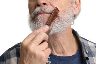 Photo of Man combing beard with comb on white background, closeup