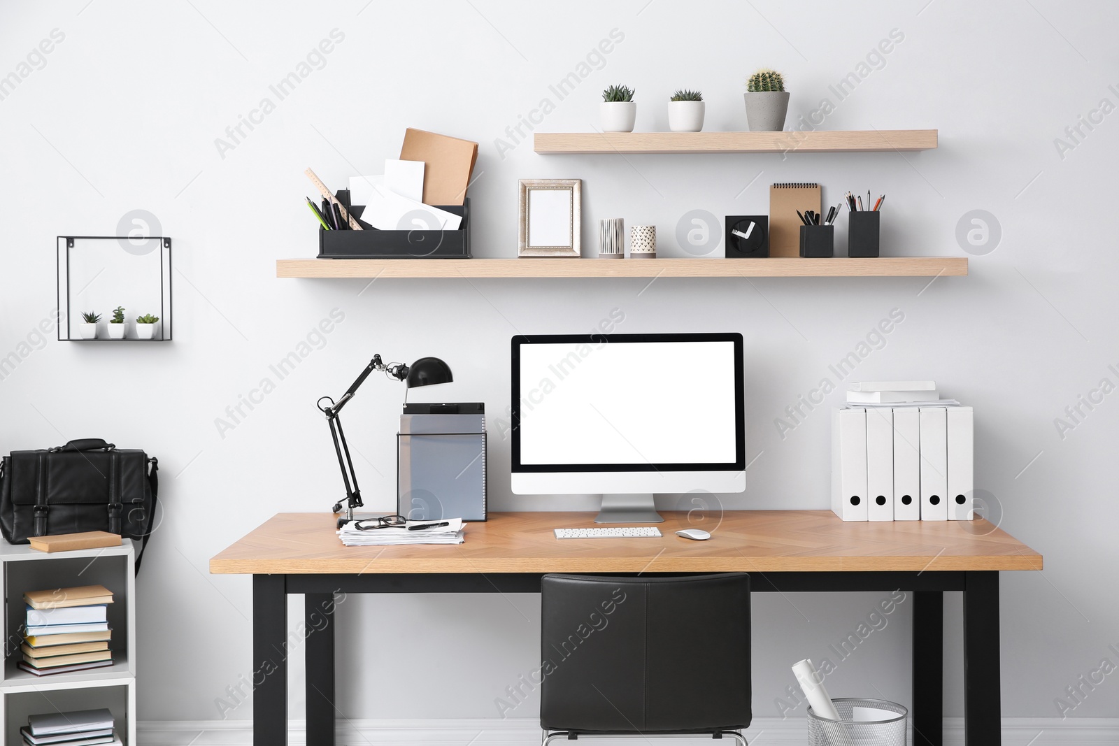 Photo of Modern computer on table in office interior. Stylish workplace