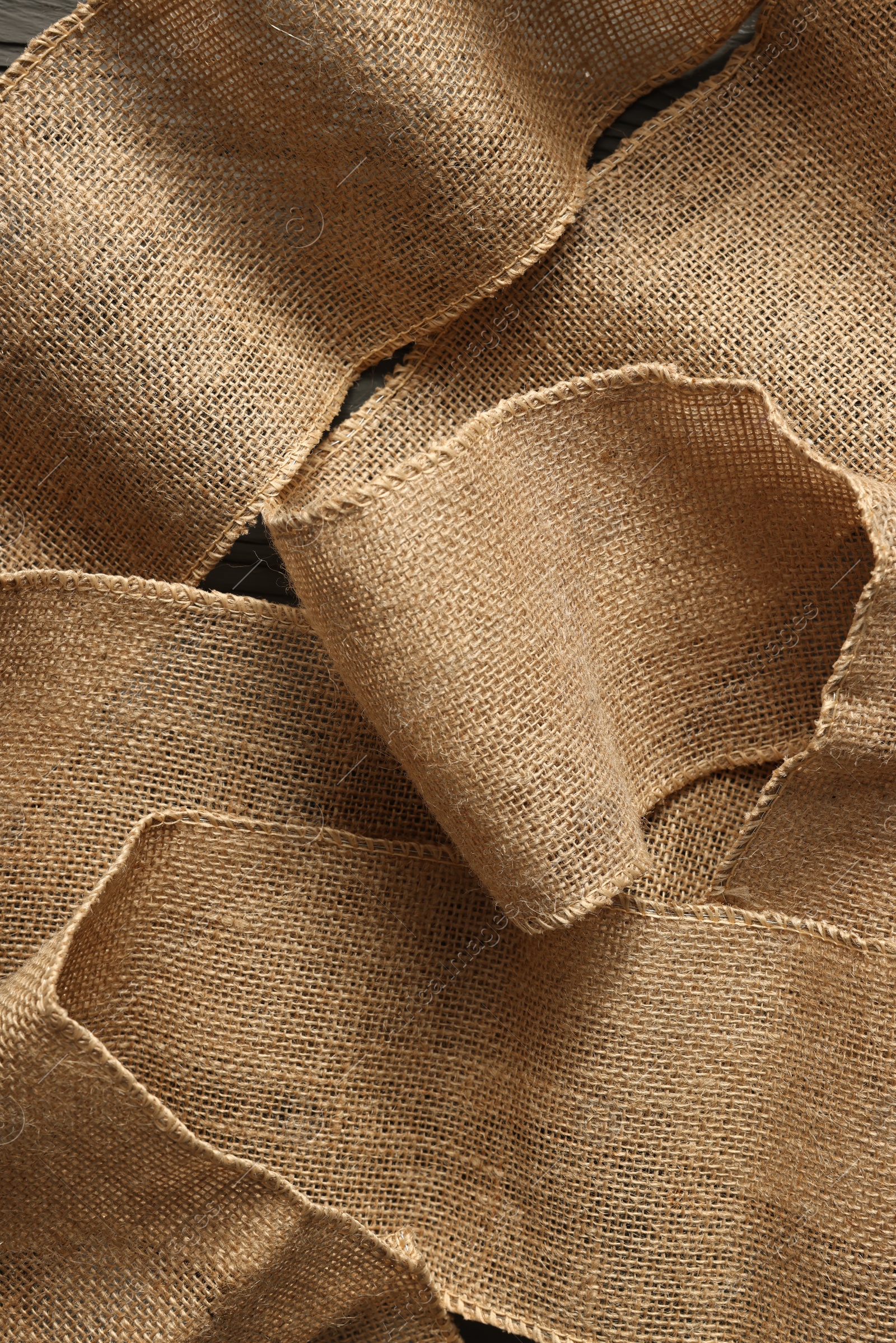 Photo of Pieces of burlap fabric as background, top view