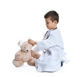 Photo of Cute child playing doctor with stuffed toy on white background