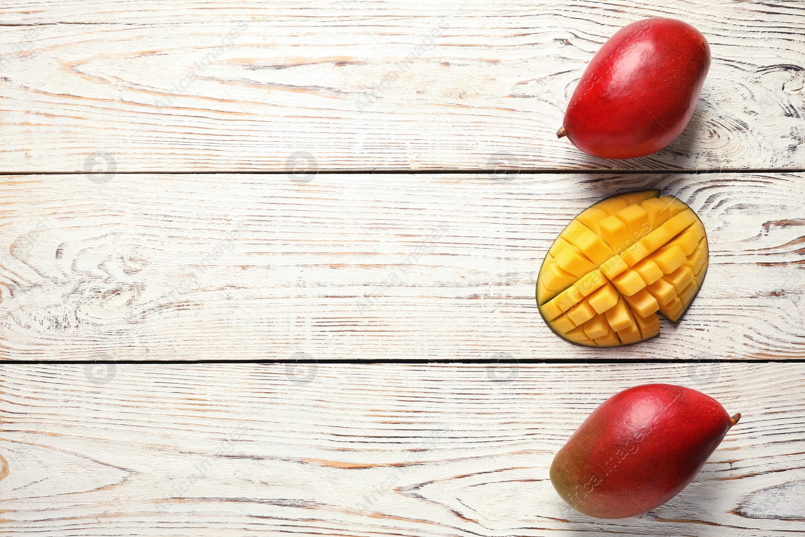 Photo of Flat lay composition with mango on white wooden background. Space for text