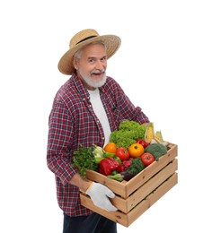 Harvesting season. Happy farmer holding wooden crate with vegetables on white background