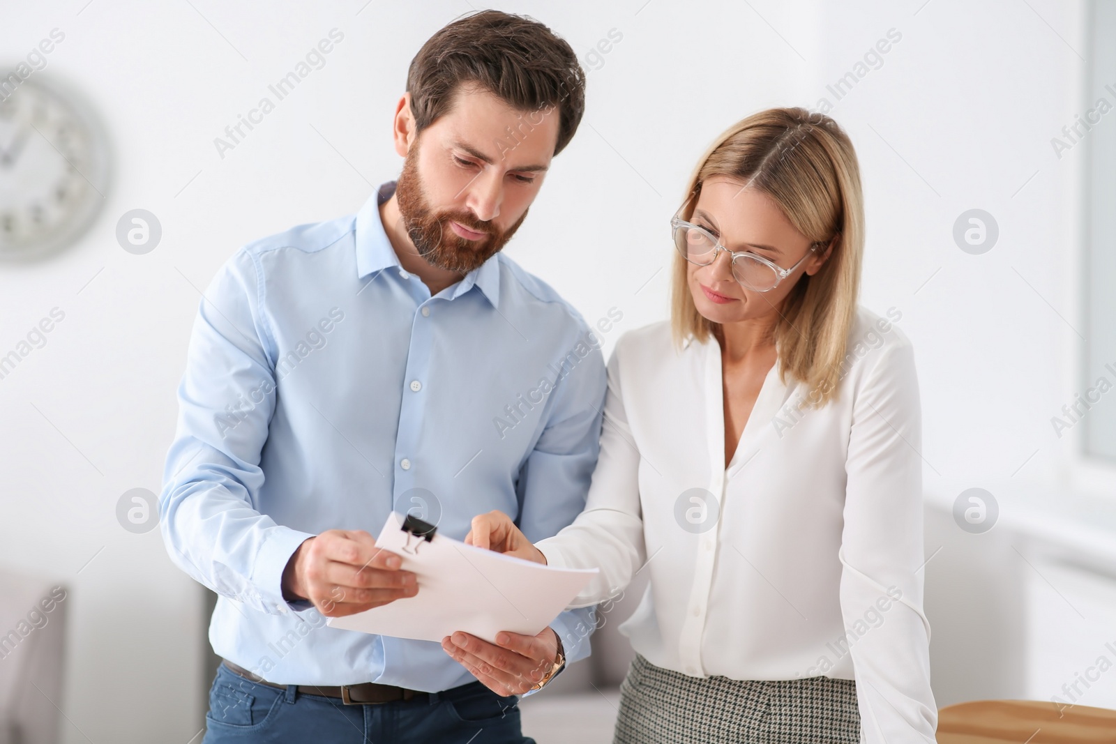 Photo of Businesspeople working with documents in modern office