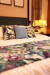 Photo of Large bed with pillows and linens in comfortable hotel room