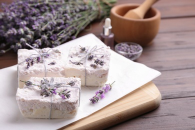 Photo of Hand made soap bars with lavender flowers on wooden table