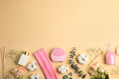 Flat lay composition with face cleansing brush on beige background. Cosmetic accessory