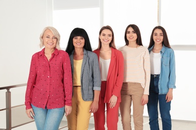 Group of ladies near window indoors. Women power concept