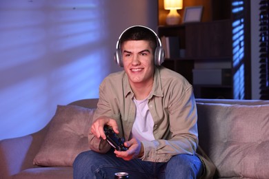 Man playing video games with controller at home