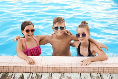 Photo of Happy children in swimming pool on sunny day