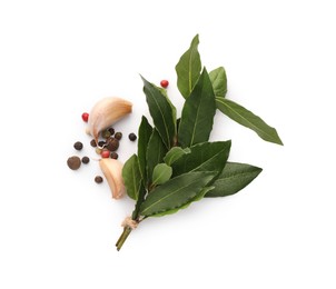 Photo of Aromatic bay leaves and spices isolated on white, top view