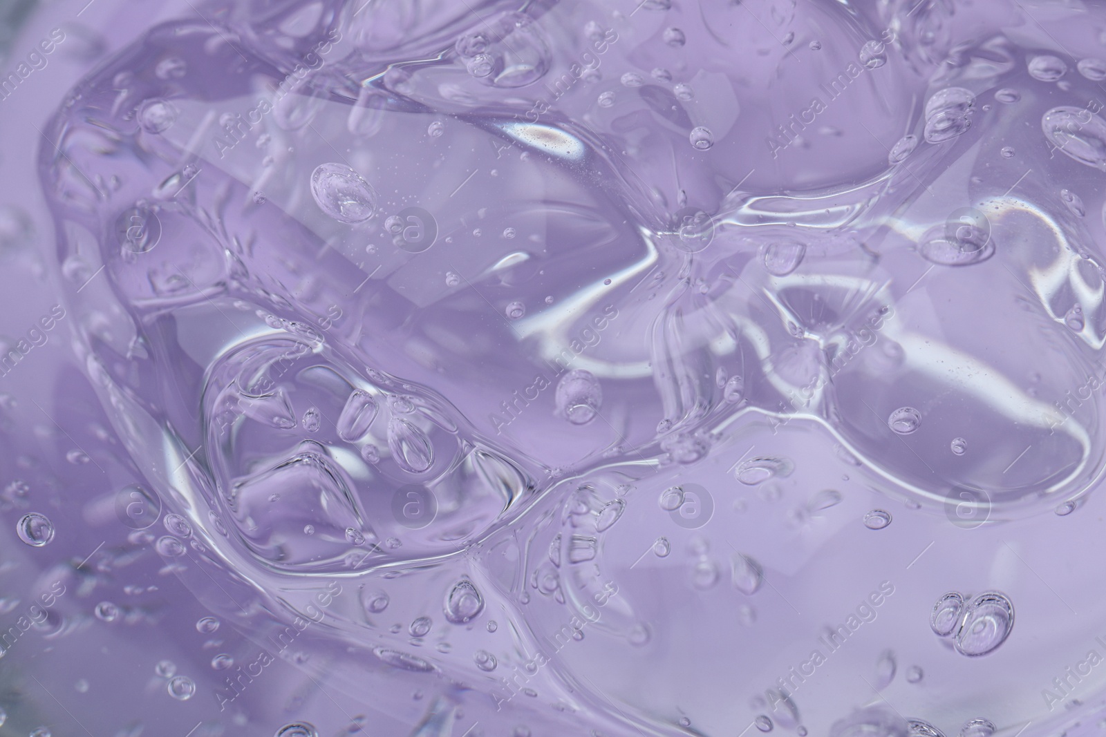 Photo of Pure transparent cosmetic gel on lilac background, closeup