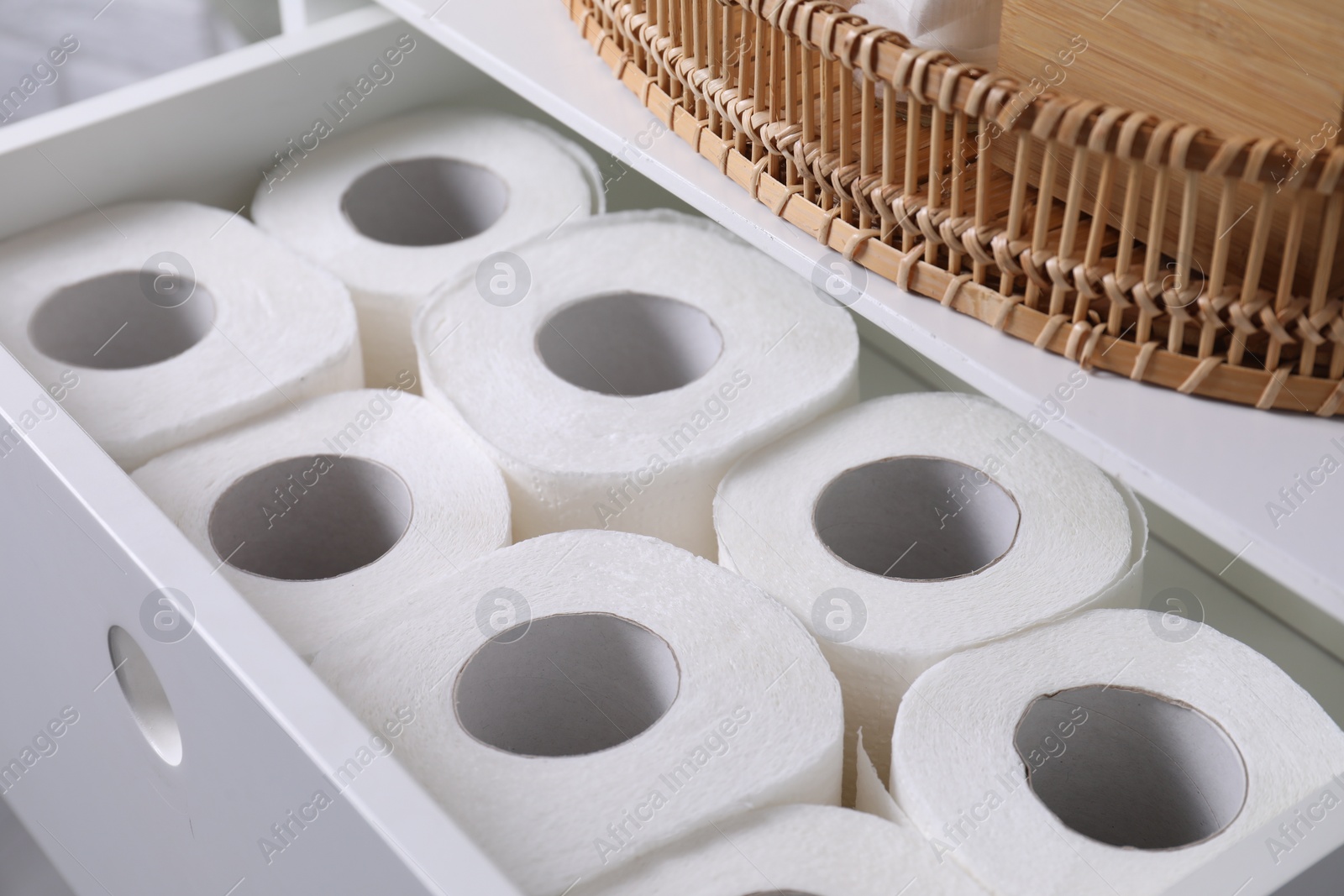 Photo of Many toilet paper rolls in white drawer indoors