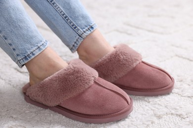 Photo of Woman in soft slippers at home, closeup