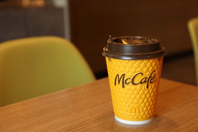 MYKOLAIV, UKRAINE - AUGUST 11, 2021: Hot McDonald's drink on table in cafe. Space for text