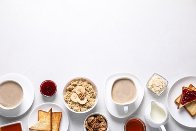 Flat lay composition with tasty breakfast food and coffee on white table. Space for text