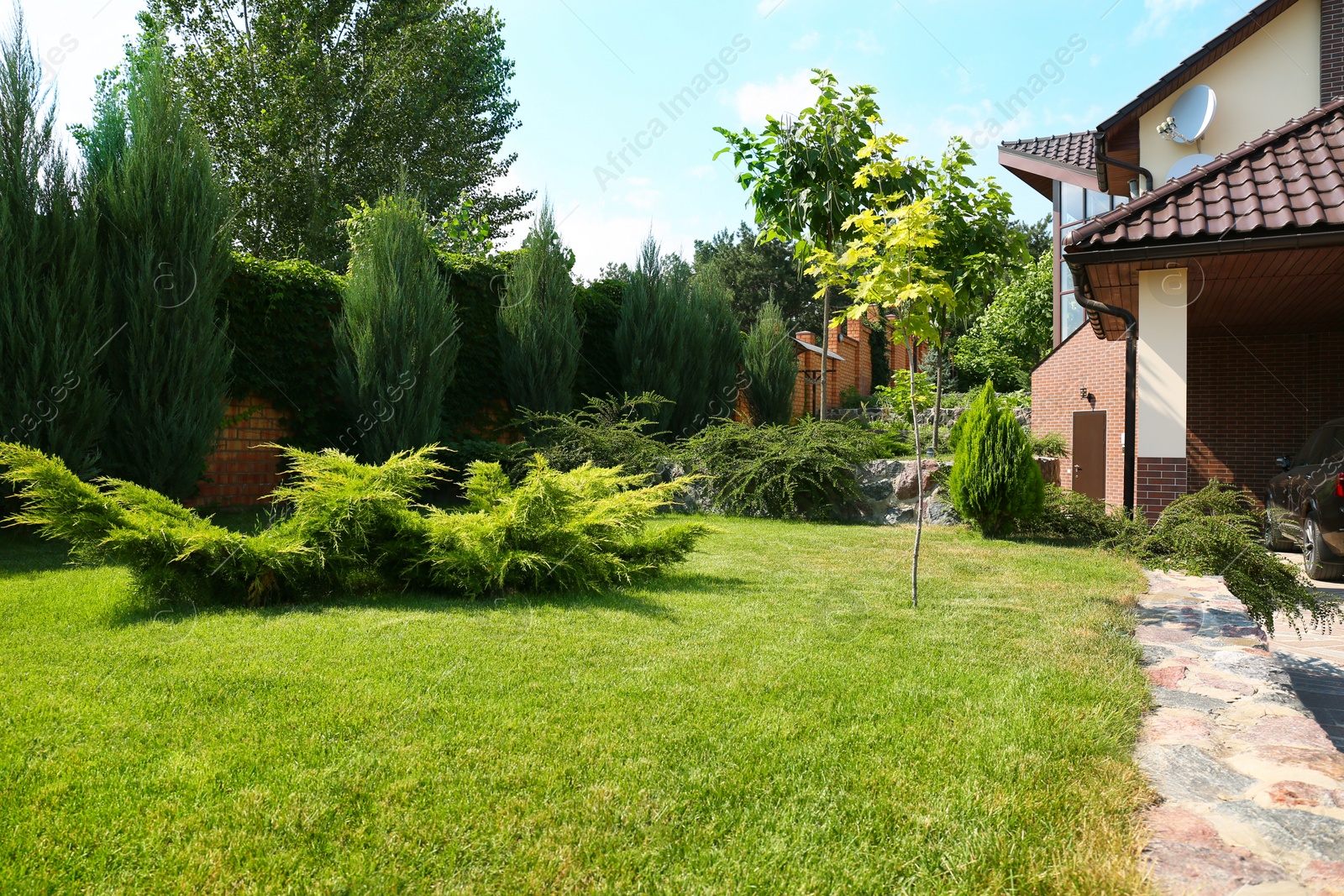 Photo of Landscape with modern house and beautiful garden on sunny day