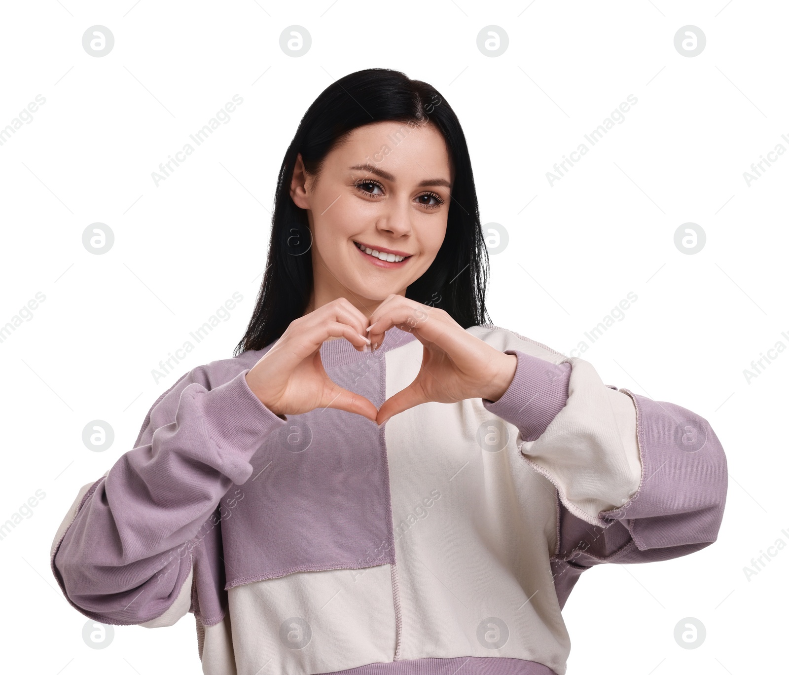 Photo of Smiling woman showing heart gesture with hands on white background