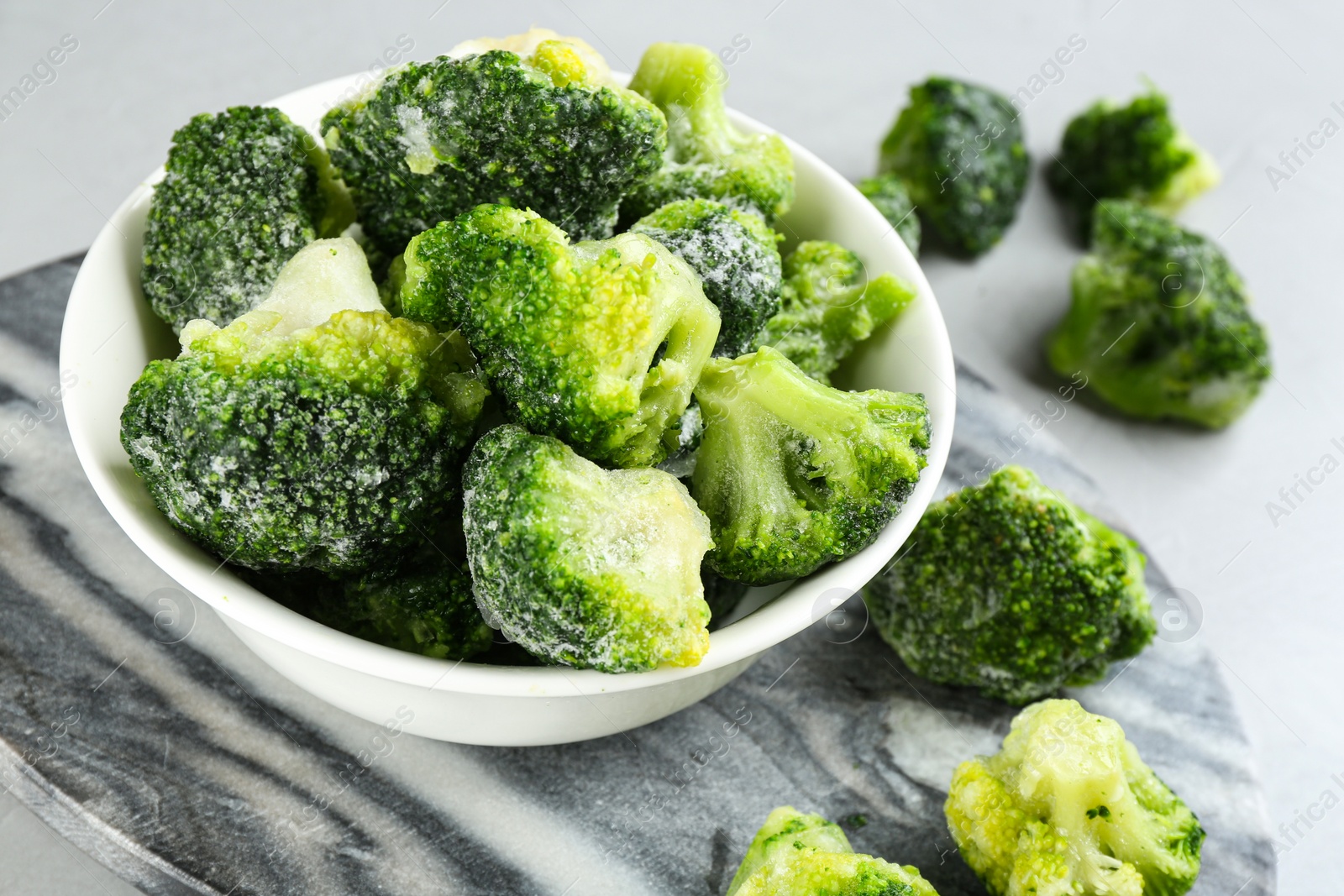 Photo of Frozen broccoli florets on table, closeup. Vegetable preservation