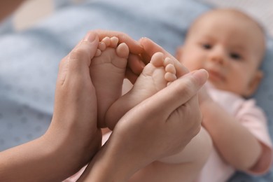 Mother with her cute little baby in crib, selective focus