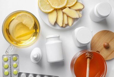 Flat lay composition with different cold remedies on white table