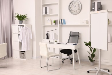 Photo of Modern medical office interior with doctor's workplace