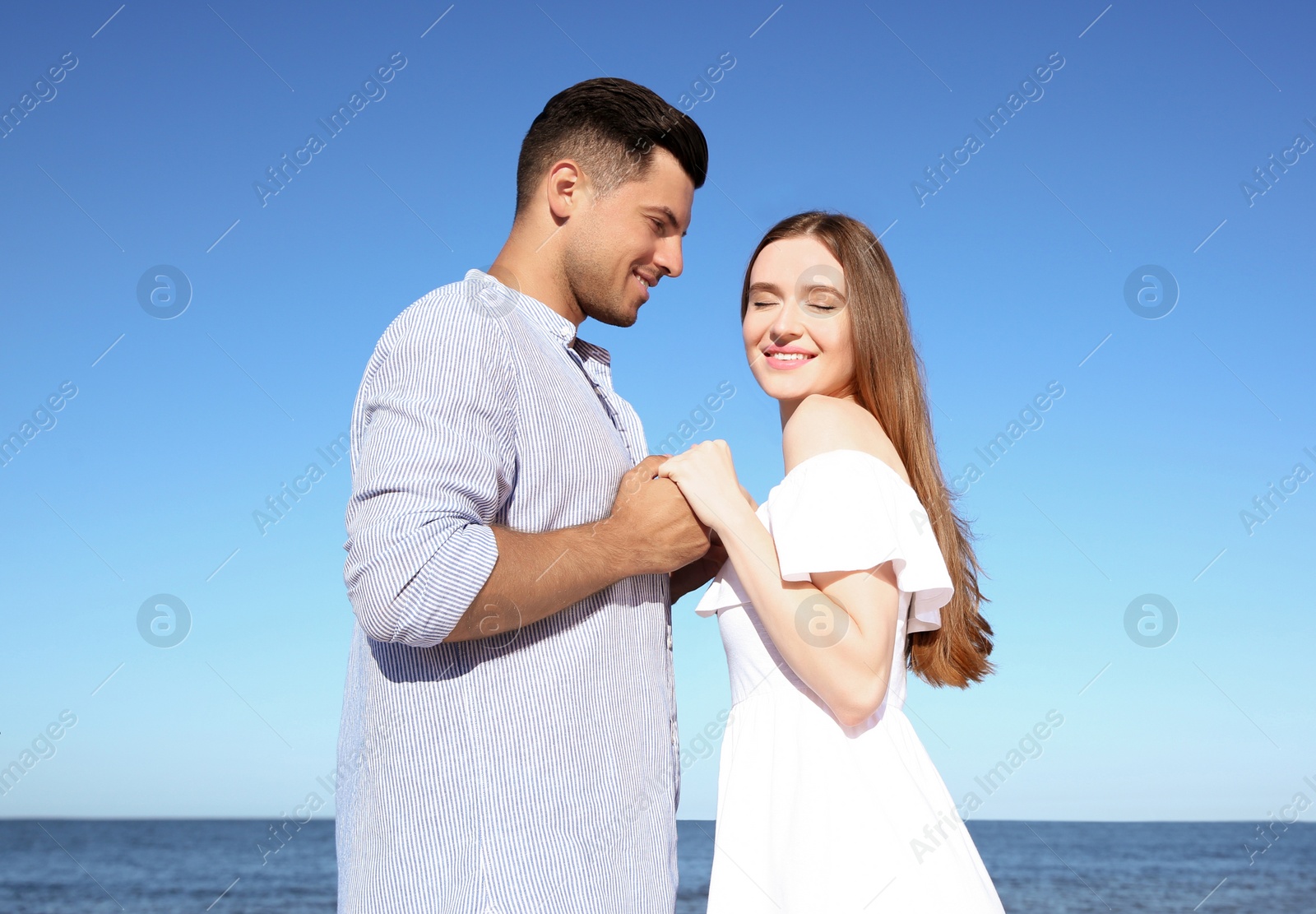 Photo of Lovely couple on beach. Space for text