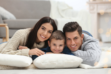 Photo of Happy family with little son spending time together at home. Winter vacation