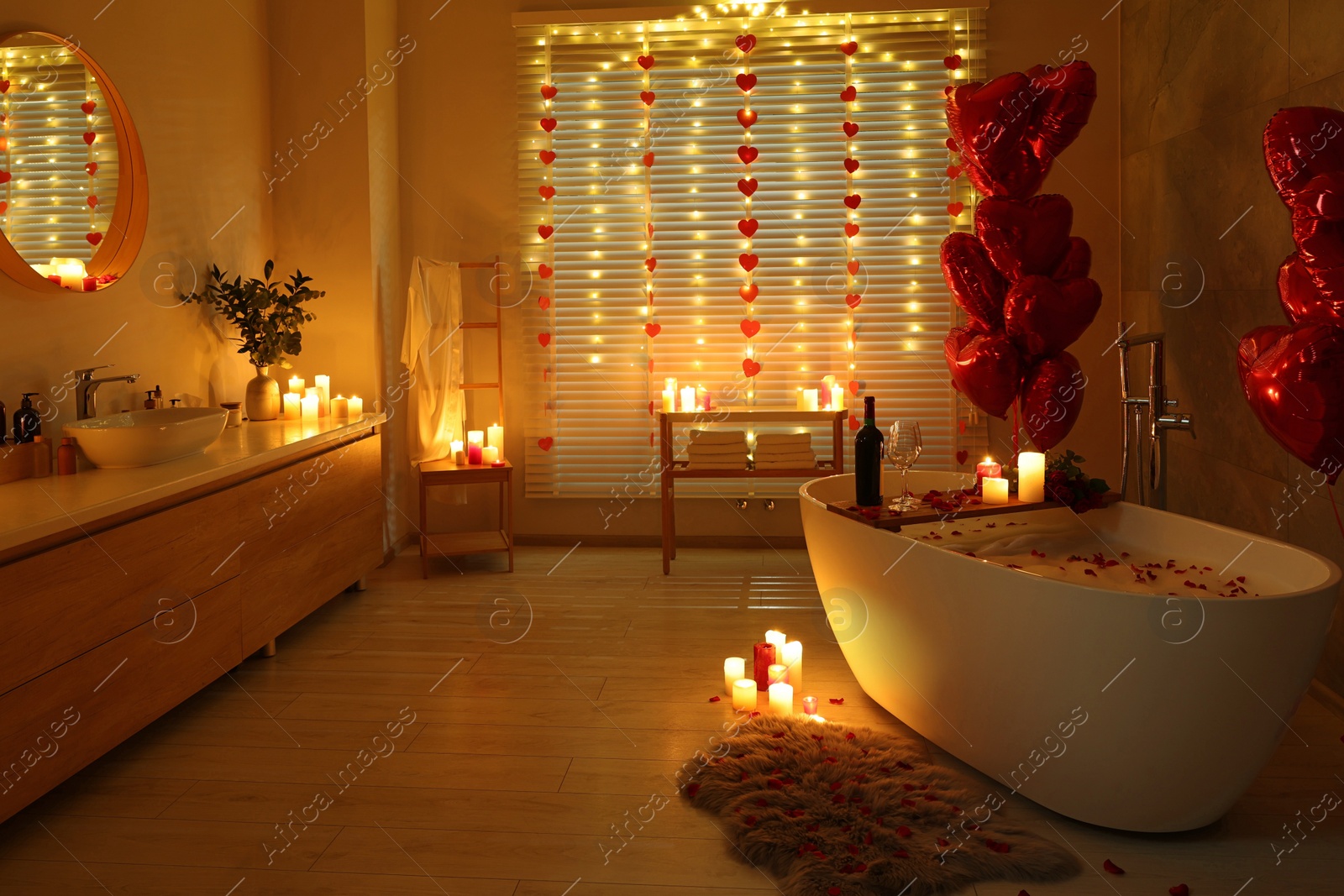 Photo of Stylish bathroom decorated for Valentine's day. Interior design