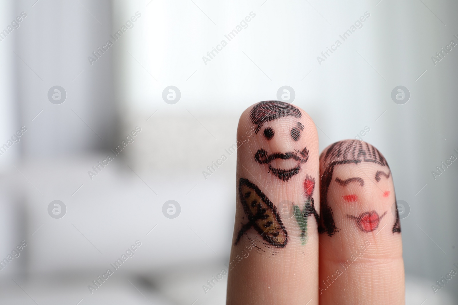 Photo of Two fingers with drawings of happy faces on blurred background, space for text. Spending time together