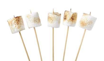 Photo of Sticks with roasted marshmallows on white background