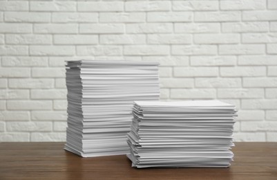 Photo of Stacks of paper sheets on wooden table