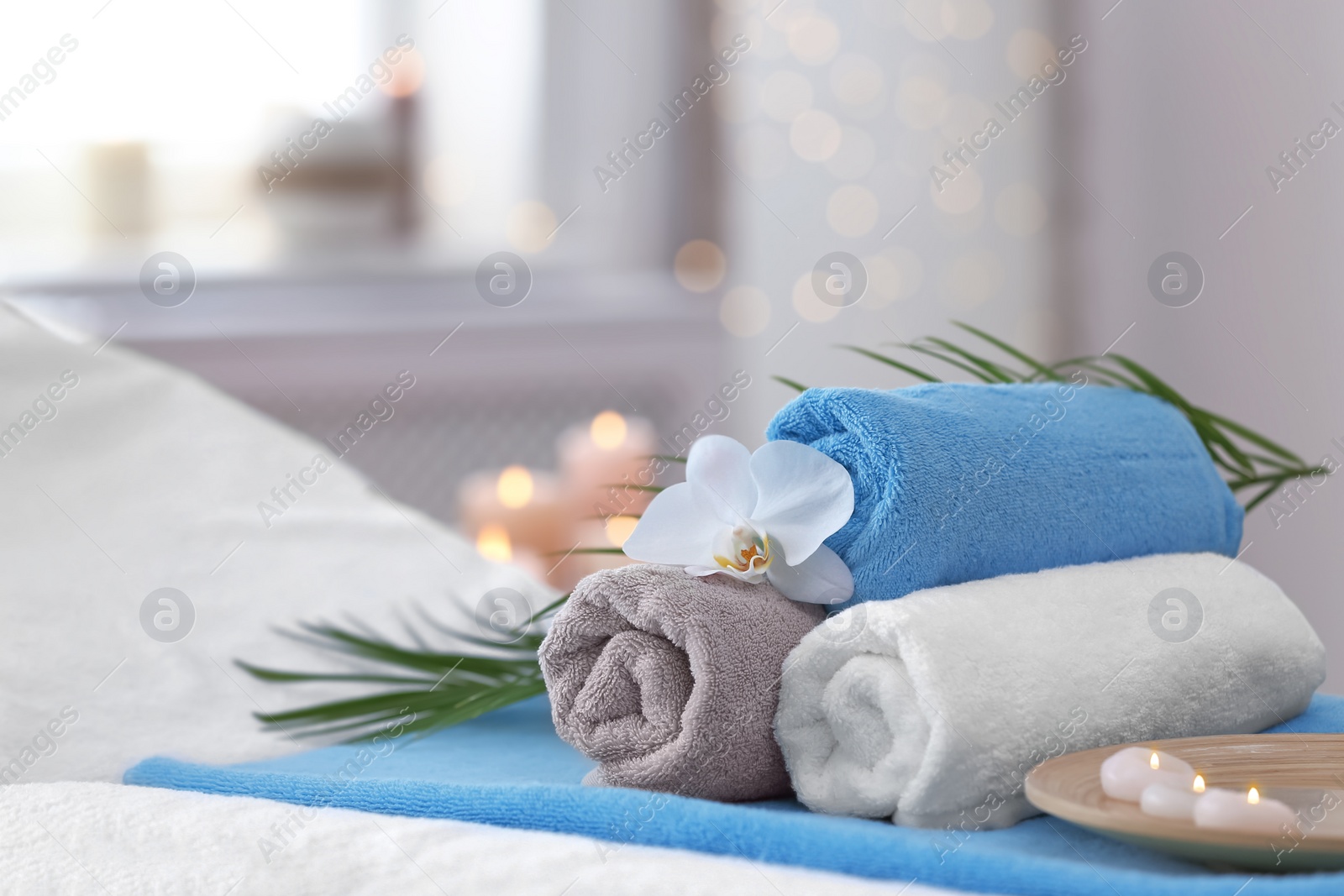 Photo of Beautiful spa composition on massage table in wellness center