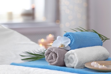 Photo of Beautiful spa composition on massage table in wellness center