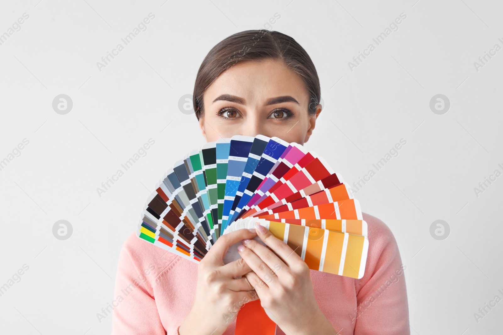 Photo of Young woman with color palette on white background