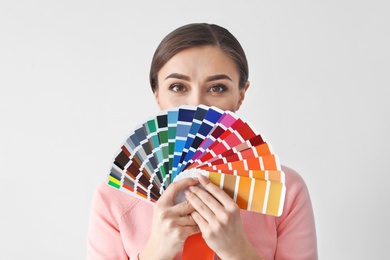 Photo of Young woman with color palette on white background