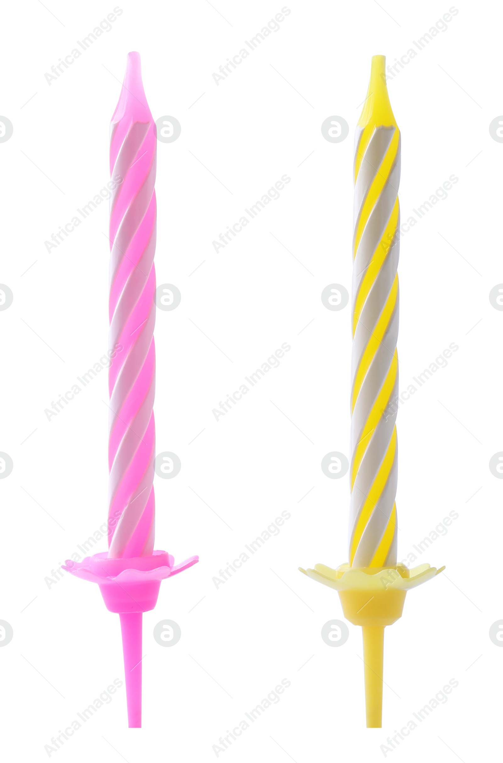 Photo of Colorful striped birthday candles in holders isolated on white