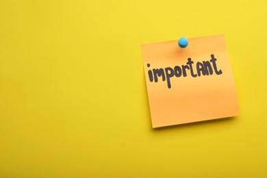 Photo of Paper note with word Important pinned on yellow background, space for text