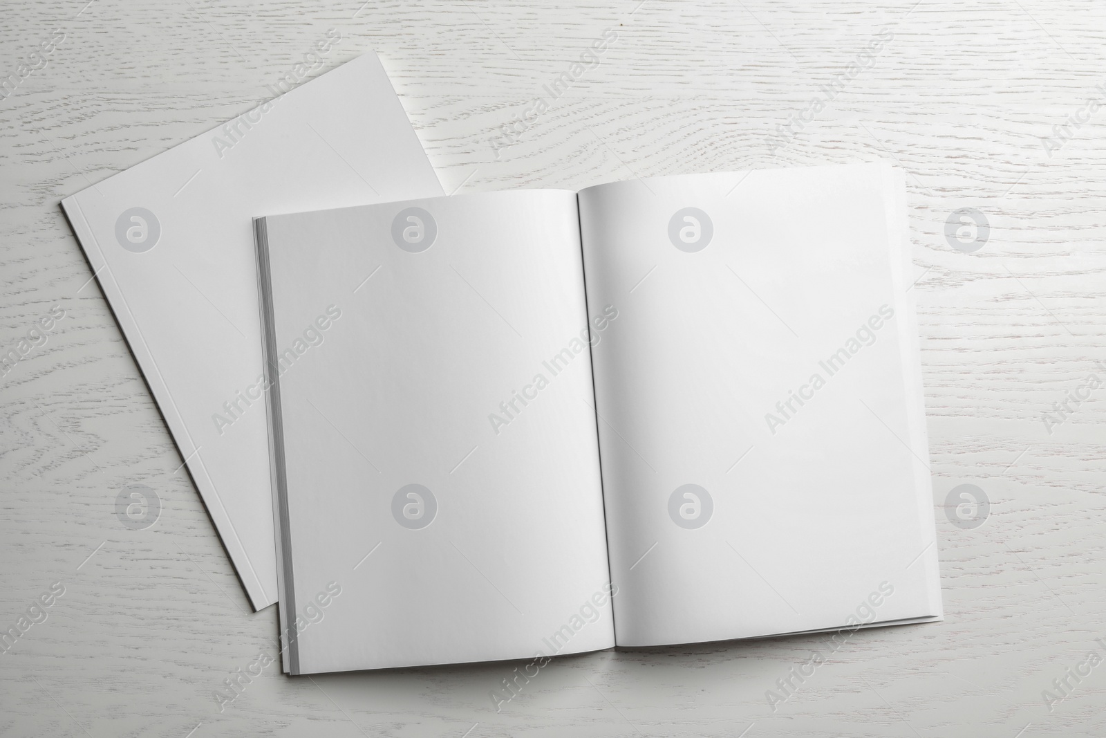 Photo of Open and closed blank brochures on wooden background, top view. Mock up for design