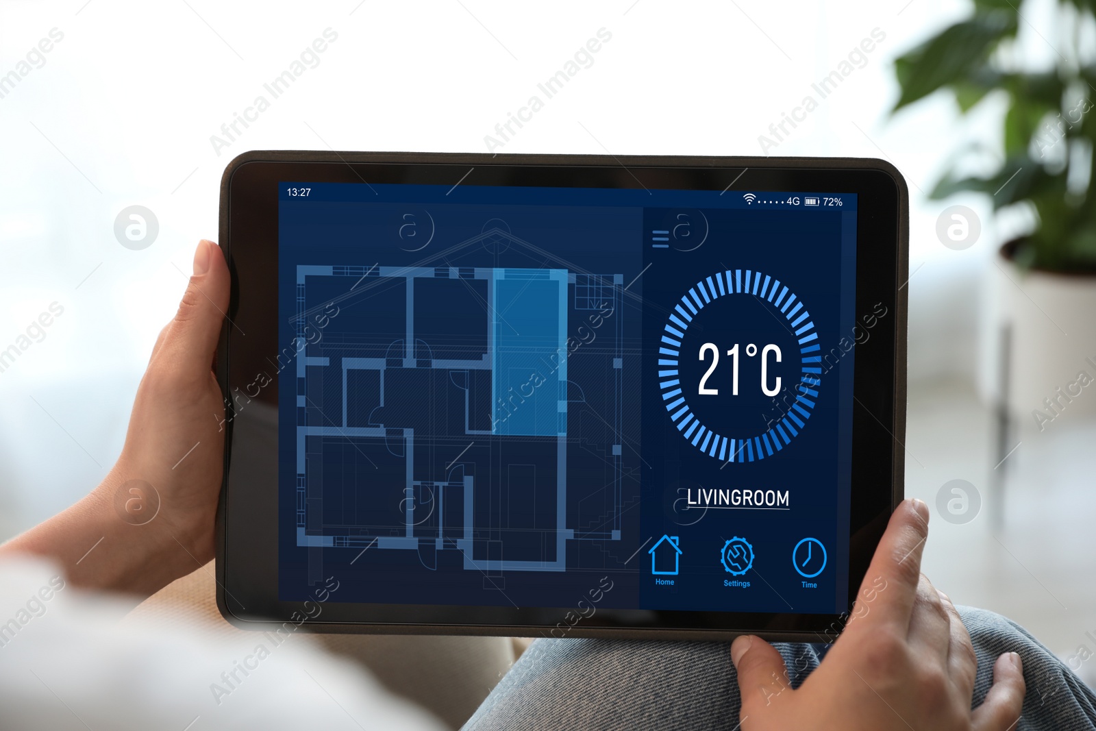 Image of Woman using tablet to control heating system in house, closeup