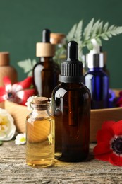 Photo of Aromatherapy. Different essential oils and flowers on wooden table