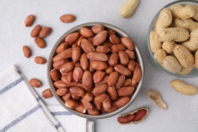 Photo of Fresh unpeeled peanuts on grey table, flat lay