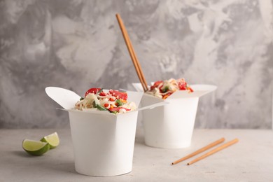 Photo of Boxes of vegetarian wok noodles with chopsticks on light table