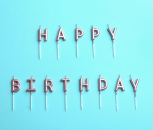 Photo of Flat lay composition with birthday candles on color background