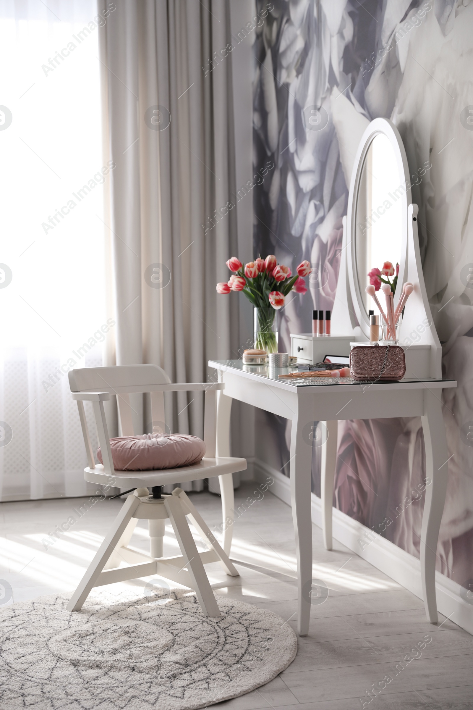 Photo of Stylish room interior with elegant dressing table and floral wallpaper