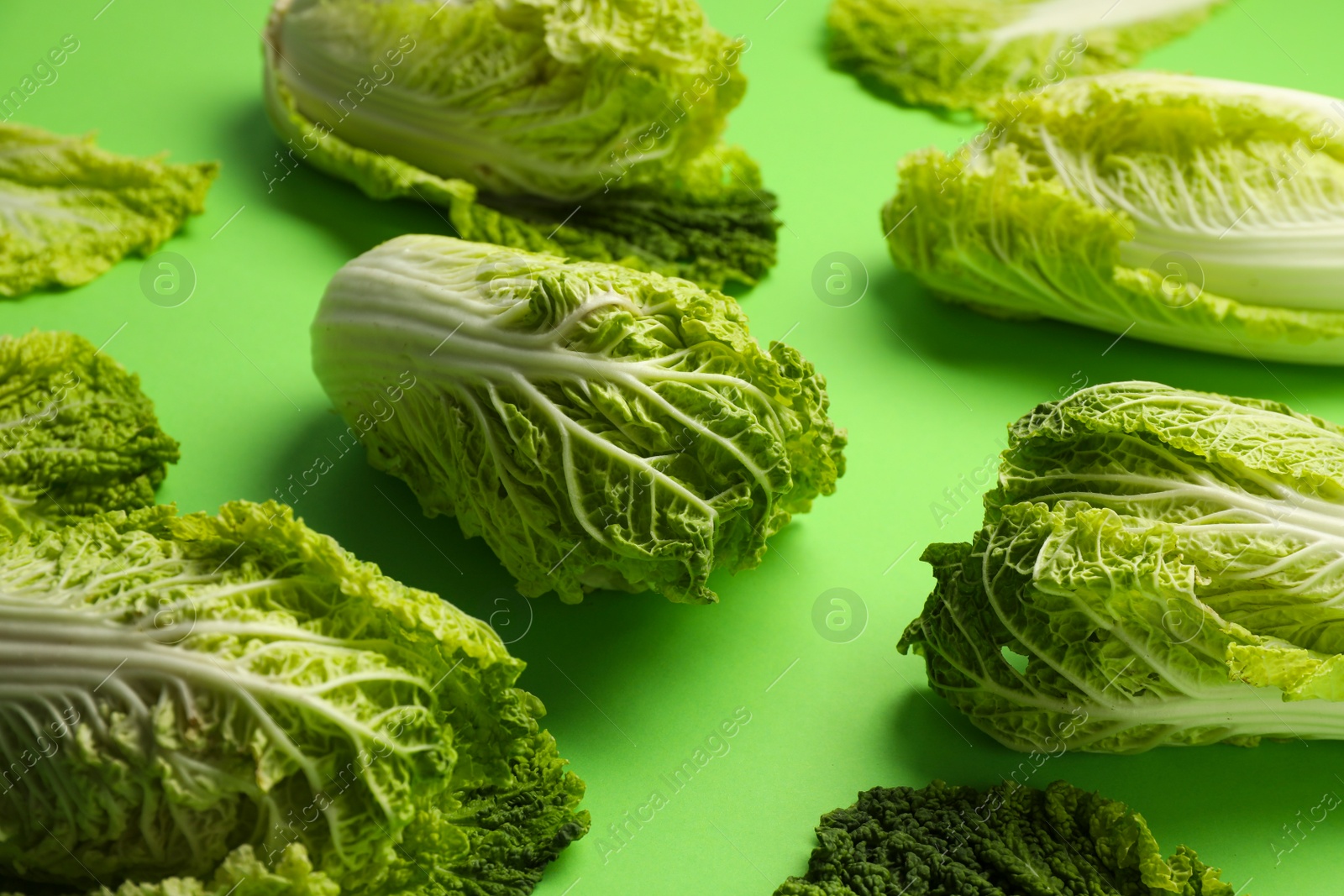 Photo of Fresh ripe Chinese cabbages on light green background