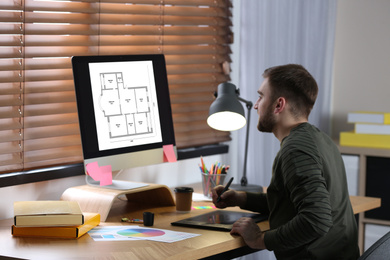 Image of Architect making project of house on computer in office