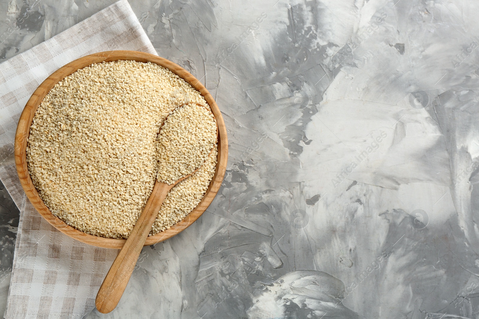 Photo of White sesame seeds on light grey table, flat lay. Space for text